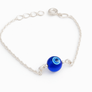 A close-up of the sterling silver bracelet, highlighting the round blue and white Evil Eye bead and the delicate chain links.