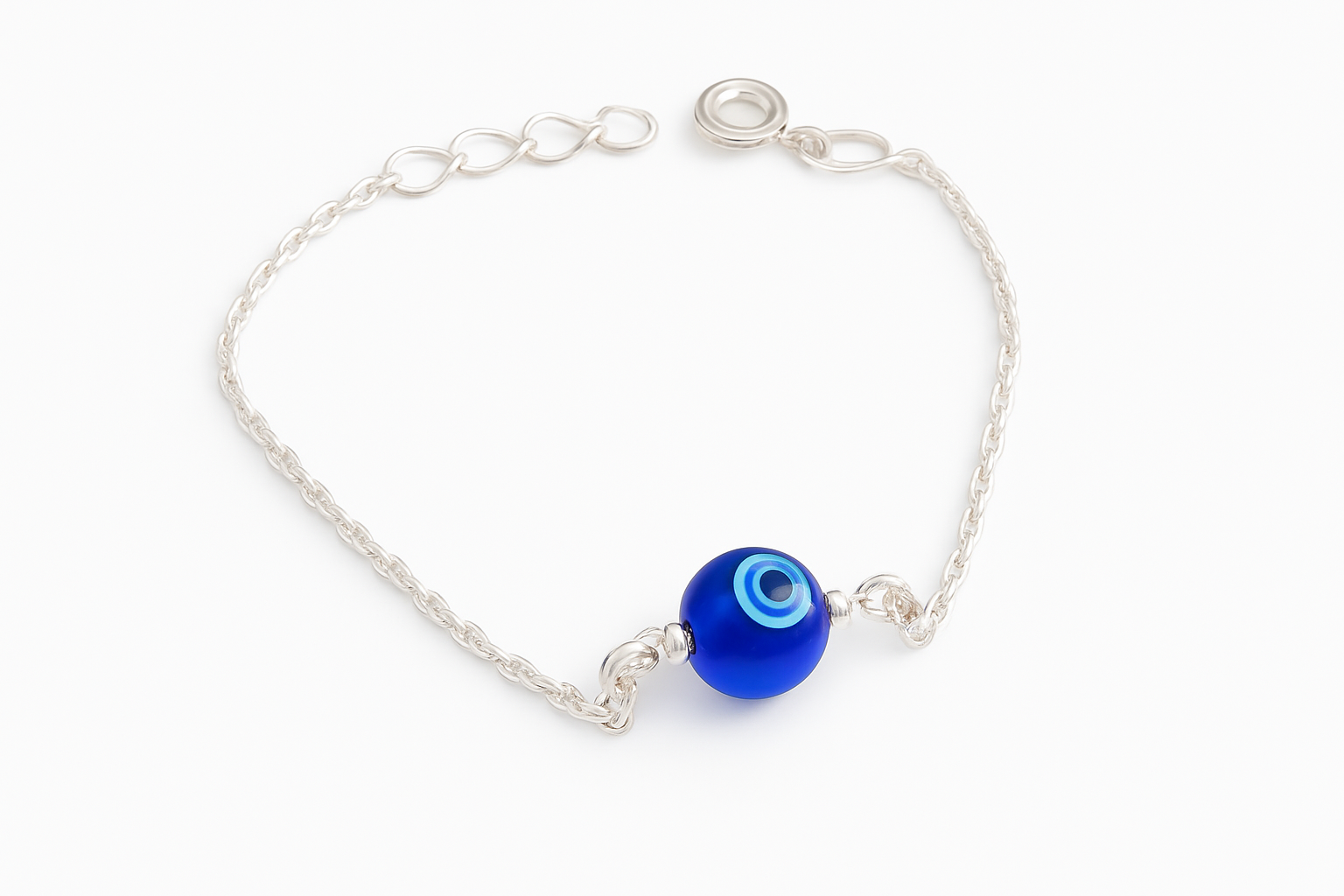 A close-up of the sterling silver bracelet, highlighting the round blue and white Evil Eye bead and the delicate chain links.