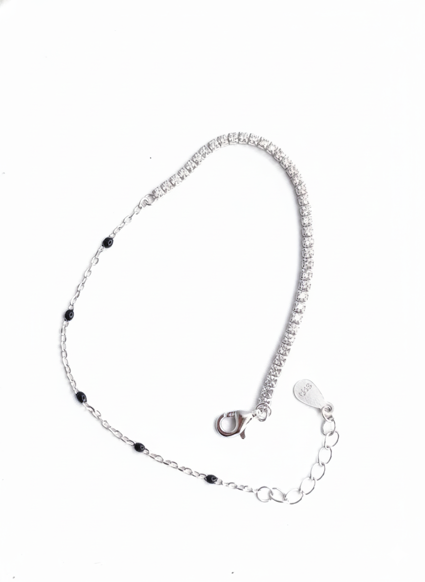 Sterling silver bracelet featuring a half tennis-style sparkle chain and delicate black bead accents with adjustable clasp