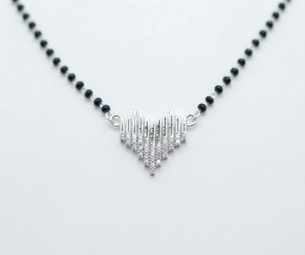 Top-down view of the silver heart mangalsutra displaying the full arrangement of traditional black beads.