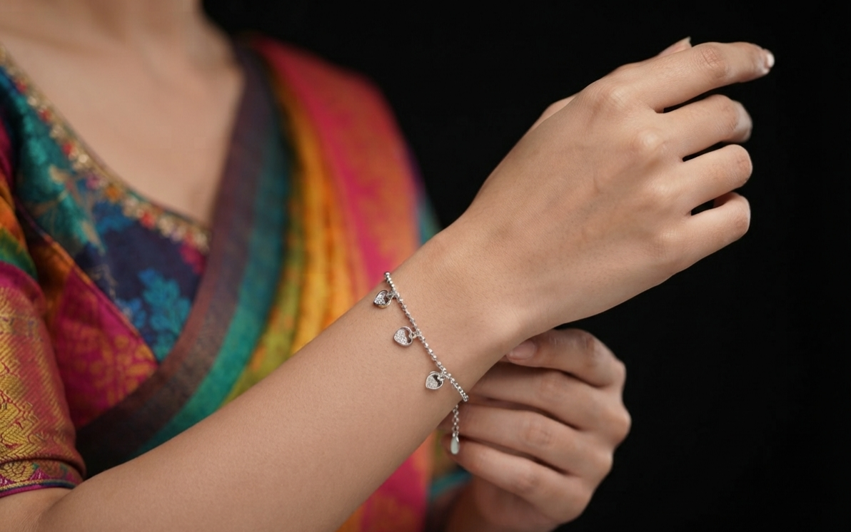 Model wearing Madhisha 925 sterling silver heart charm rakhi bracelet on wrist